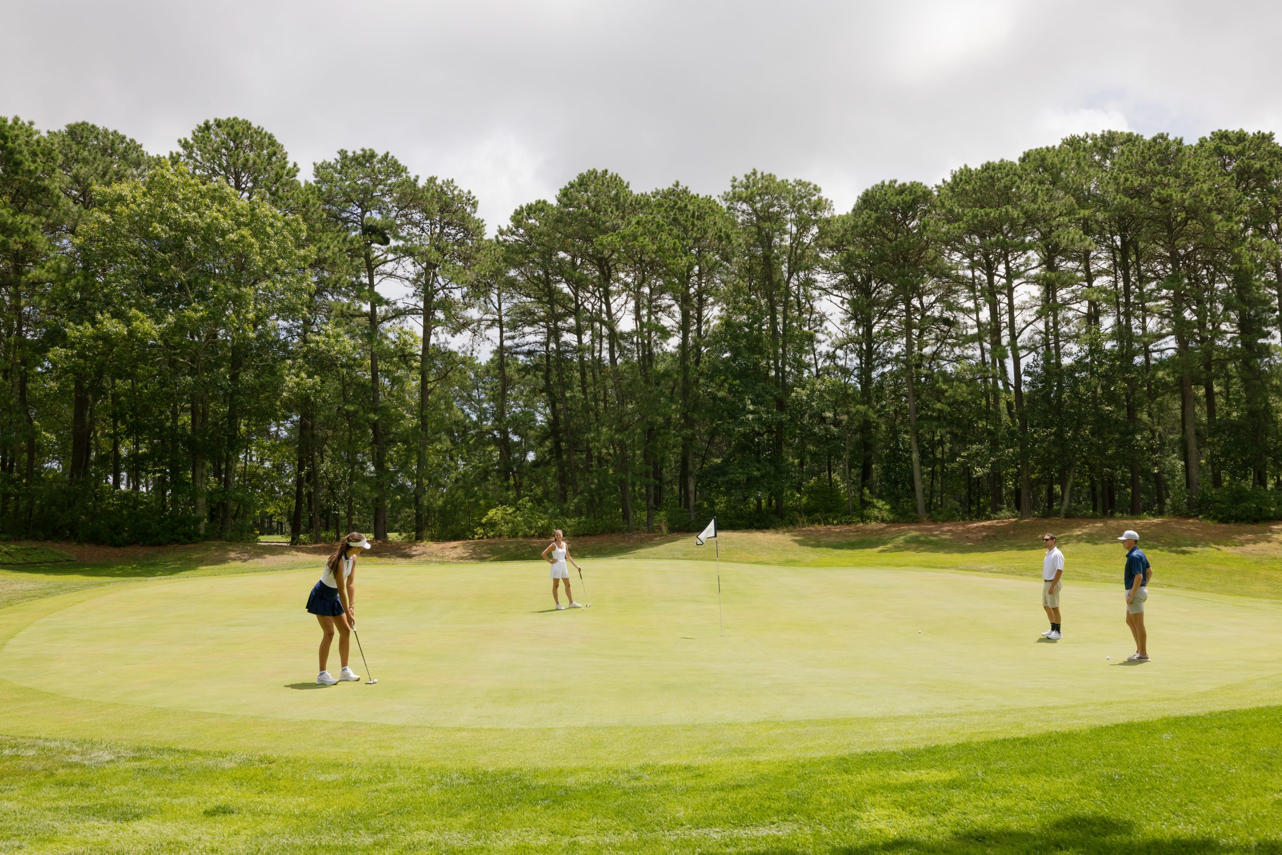 A group playing golf on the green at LBI National