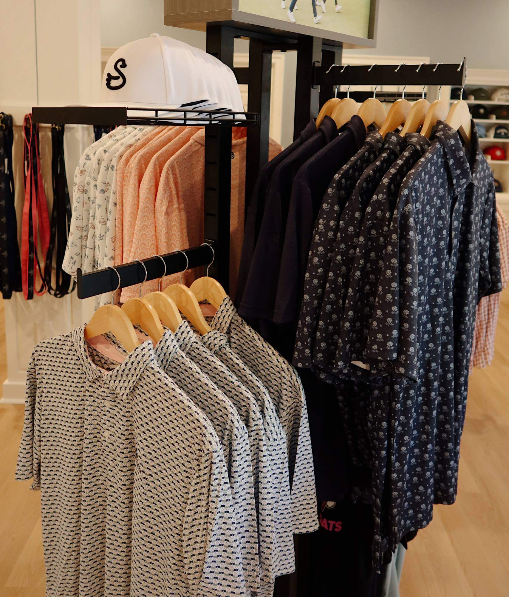 LBI National Golf & Resort pro shop clothing display featuring patterned golf shirts and caps