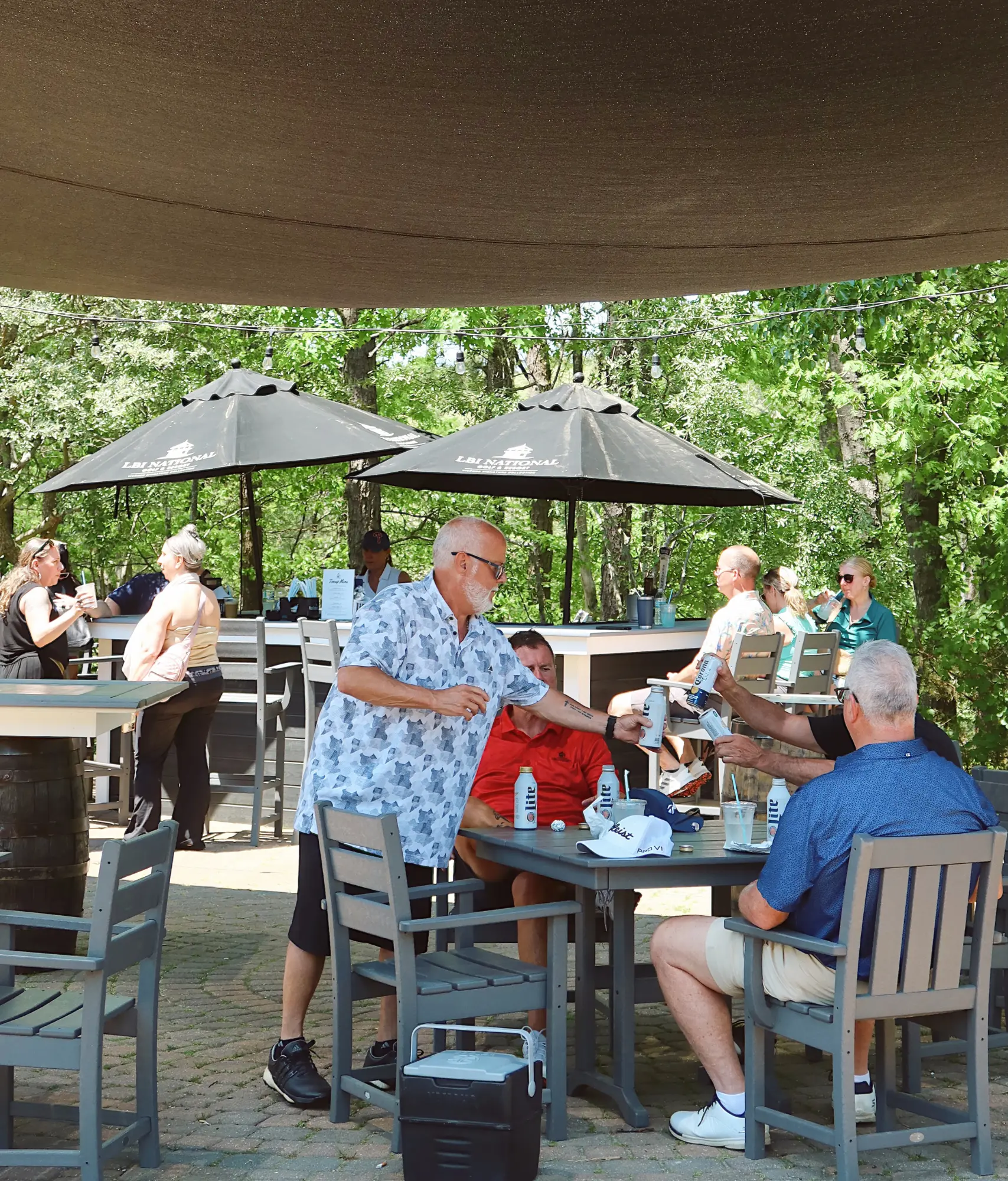Guests enjoying drinks and outdoor dining at LBI National